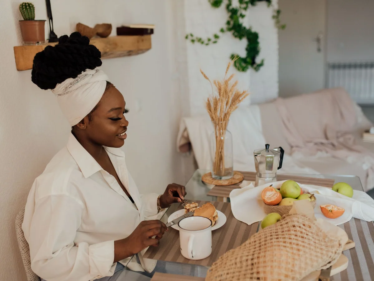 Woman setting a small balcony table for an intimate dinner