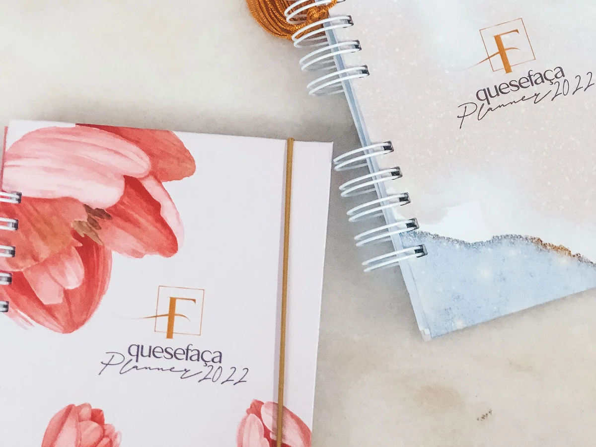 Woman reviewing her month with a calendar and notebook at a kitchen table