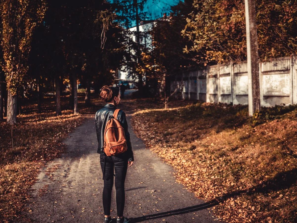 Woman walking through her neighborhood on a thoughtful afternoon route
