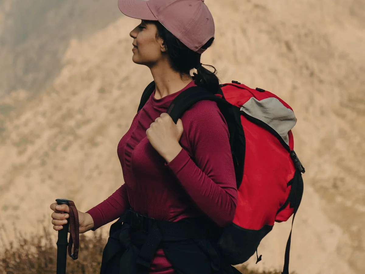 Woman planning a city break with a map and compact travel bag